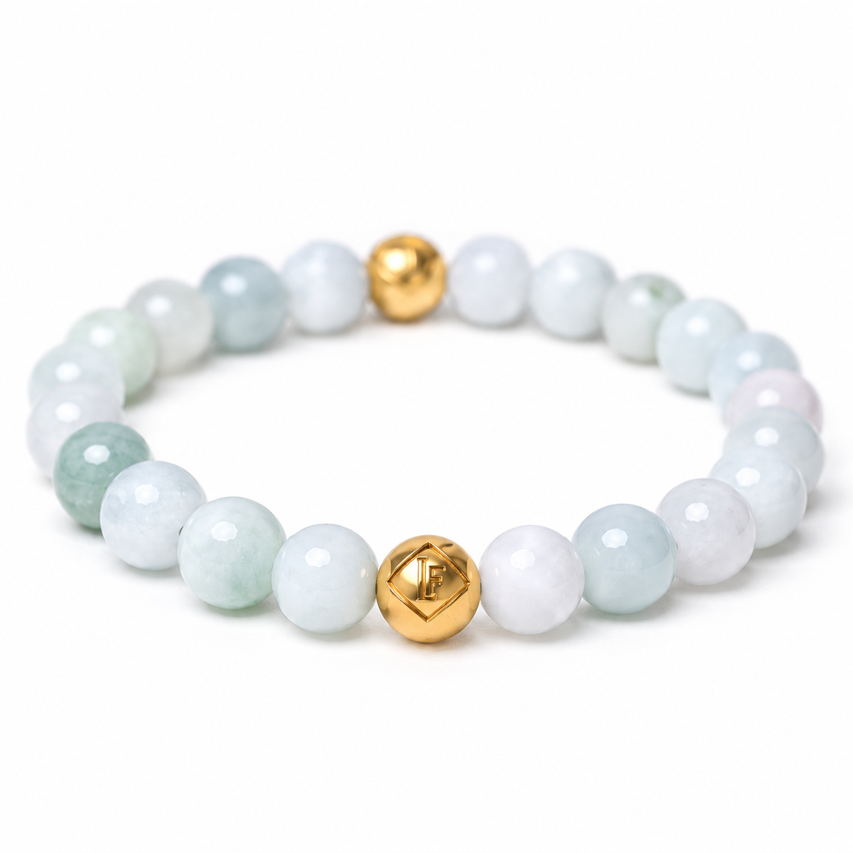 A beaded stretch bracelet featuring light green and white polished gemstone beads, accented by two shiny 18k gold-toned metal beads, shown on a clean white background.