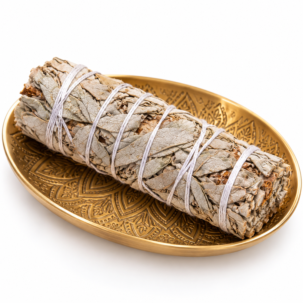 An organic Mexican sage stick bundled using a twine on a gold plate.