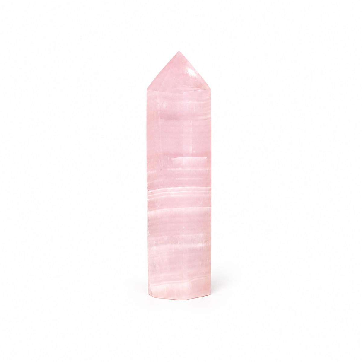 A polished pink crystal point tower, likely rose quartz, standing vertically against a seamless white background.